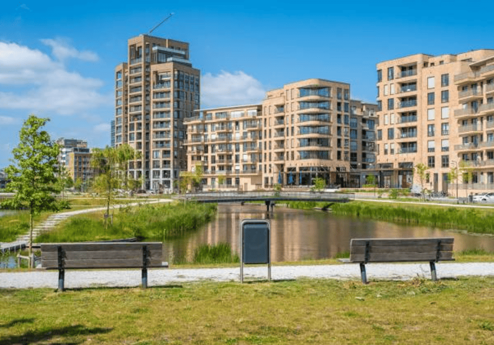 Modern apartment buildings next to waterfront park.