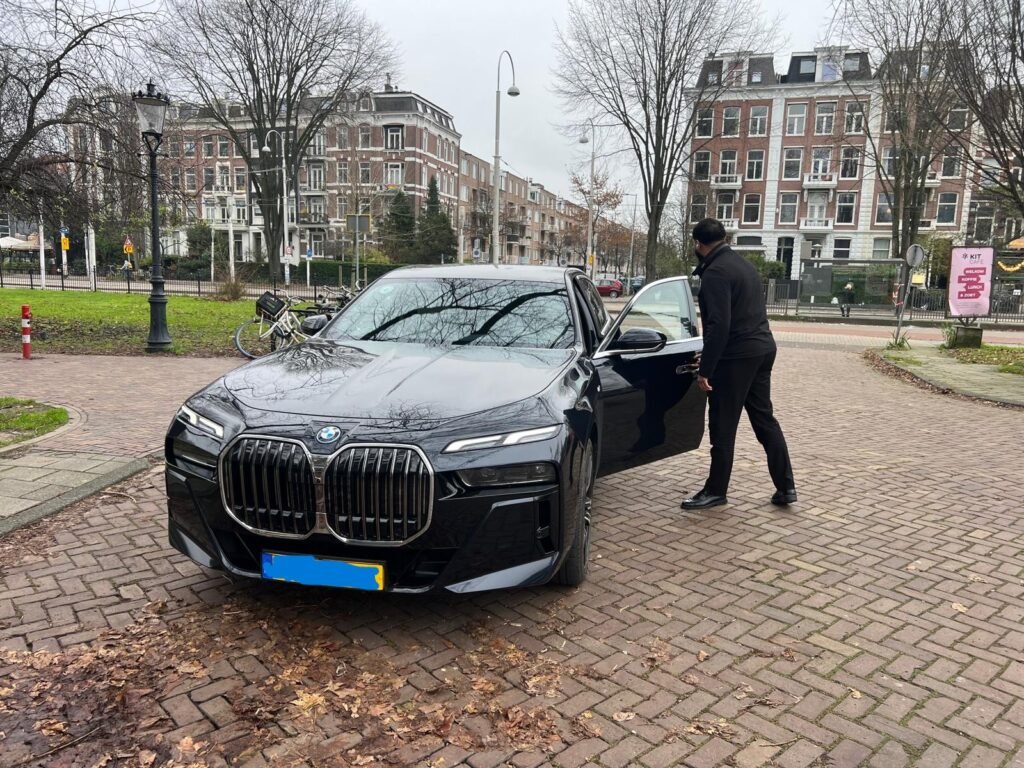 Man opening door of black BMW.