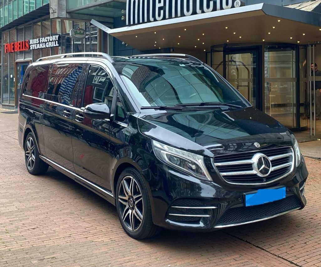 Black Mercedes van parked outside an Inntel Hotels entrance.
